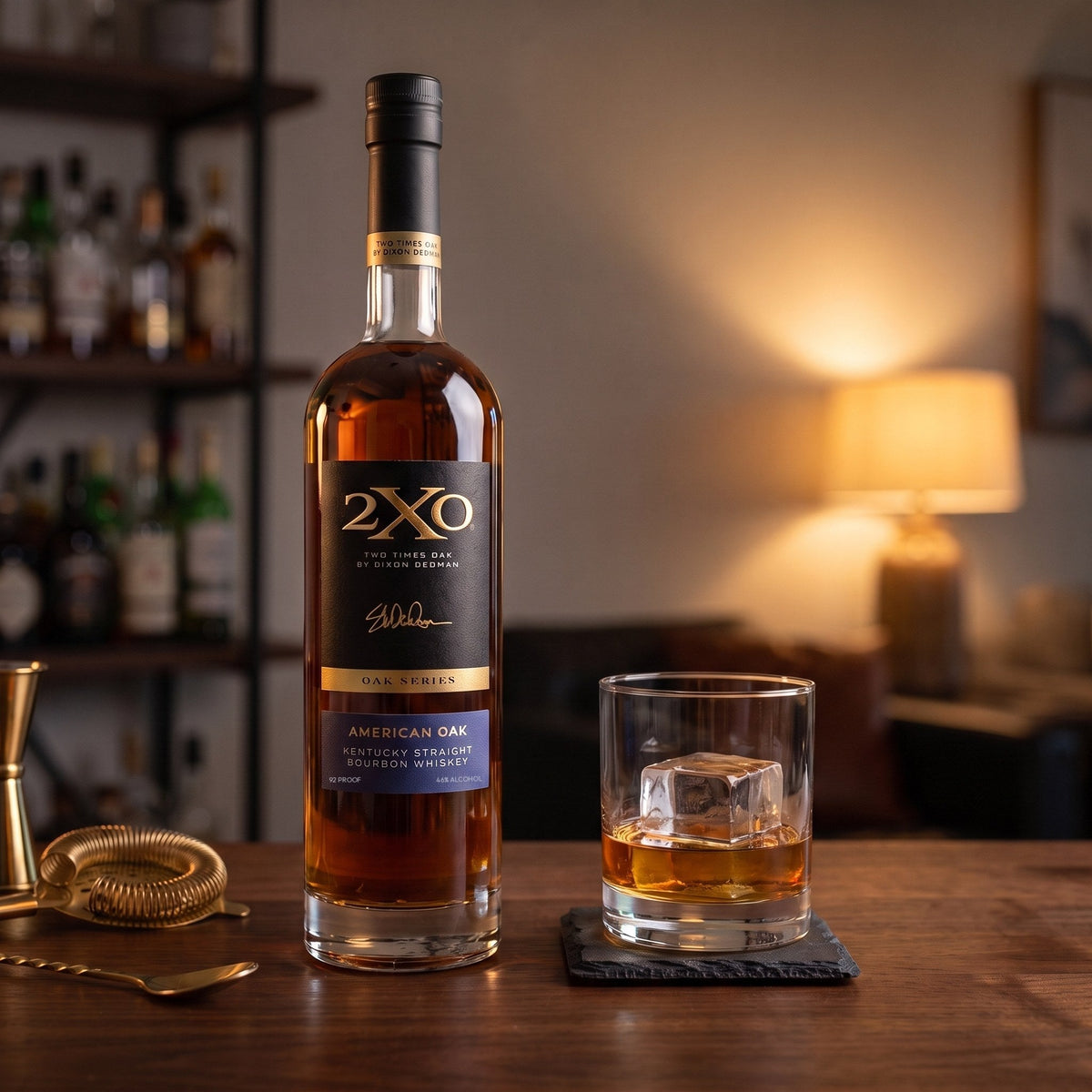 A bottle of 2XO American Oak Kentucky Straight Bourbon on a home bar beside a rocks glass