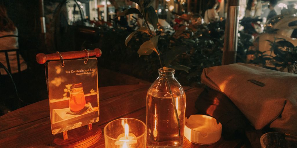 a wooden table topped with candles and bottles