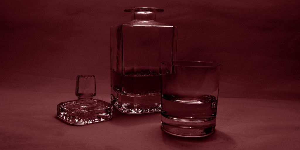 bourbon tasting event with various bottles and glasses, cozy bar setting