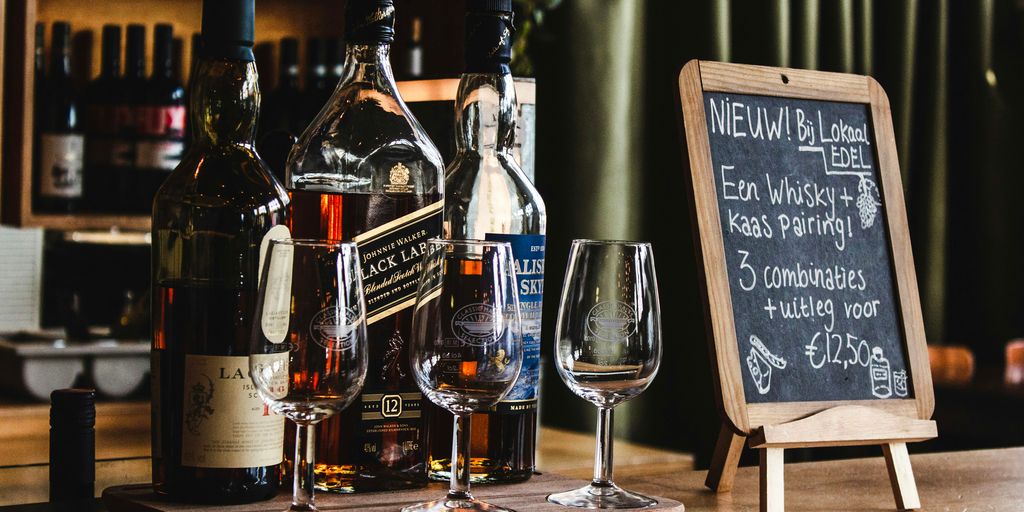 wine bottles and wine glasses on brown surface
