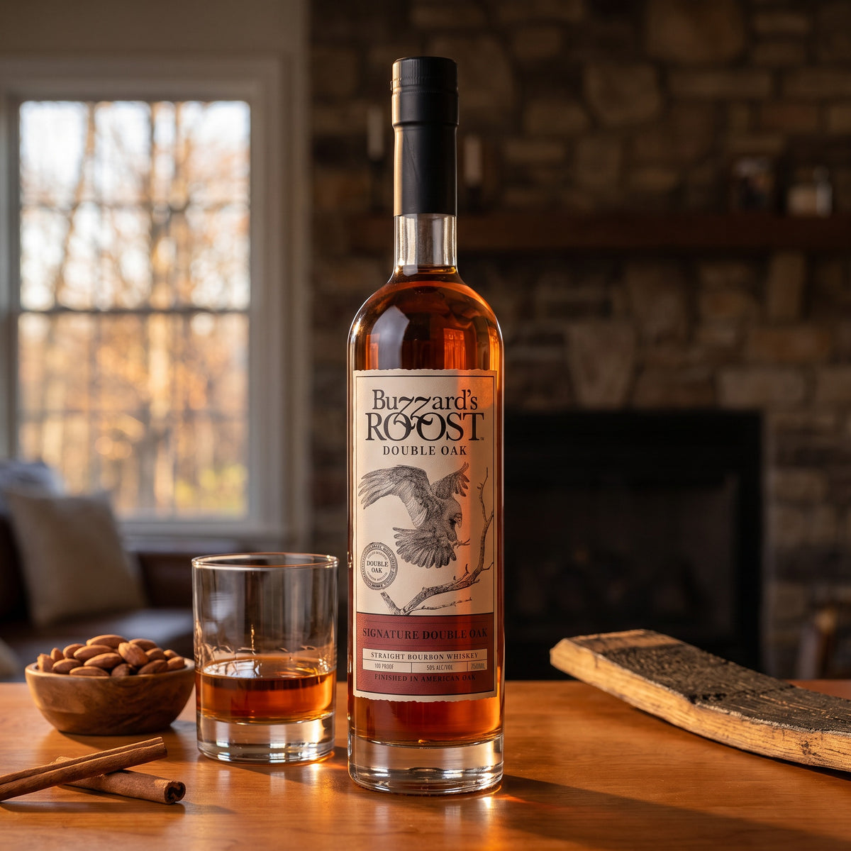 Buzzard's Roost Signature Double Oak Bourbon bottle on a cherrywood home bar beside a neat pour, roasted almonds and cinnamon sticks